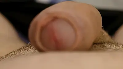 Cumshot very close up man wanks uncut erect cock cumming covering hand and penis with cum in selfie